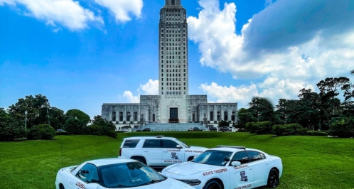Louisiana State Police patrol vehicles in front of the Louisiana State Capitol.