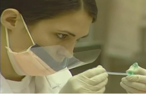 Technician working with DNA samples in a secure lab environment